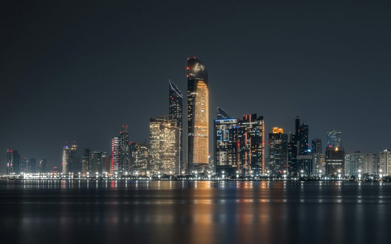 Abu Dhabi skyline at night across the waterfront for an evening guide