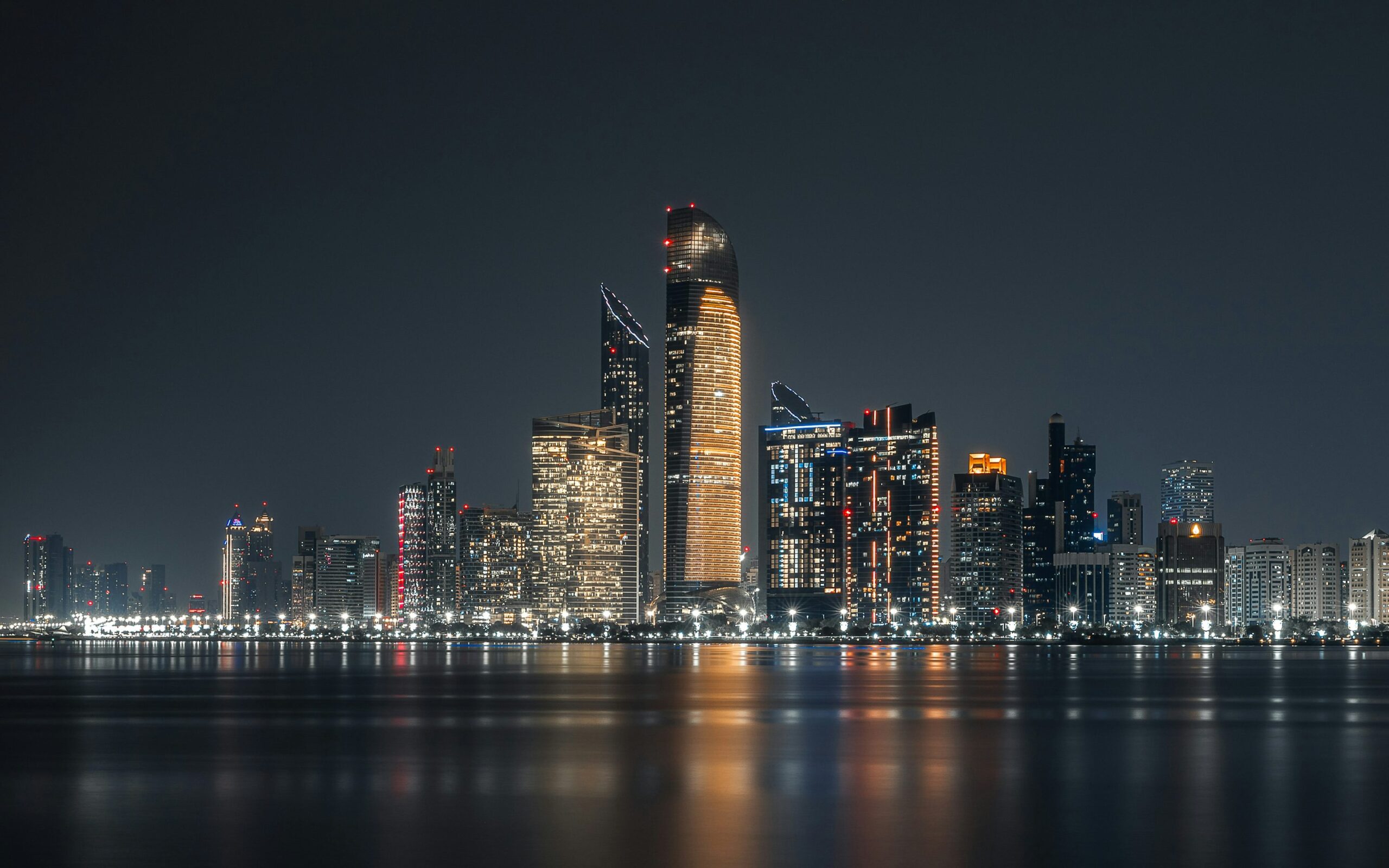 Abu Dhabi skyline at night across the waterfront for an evening guide