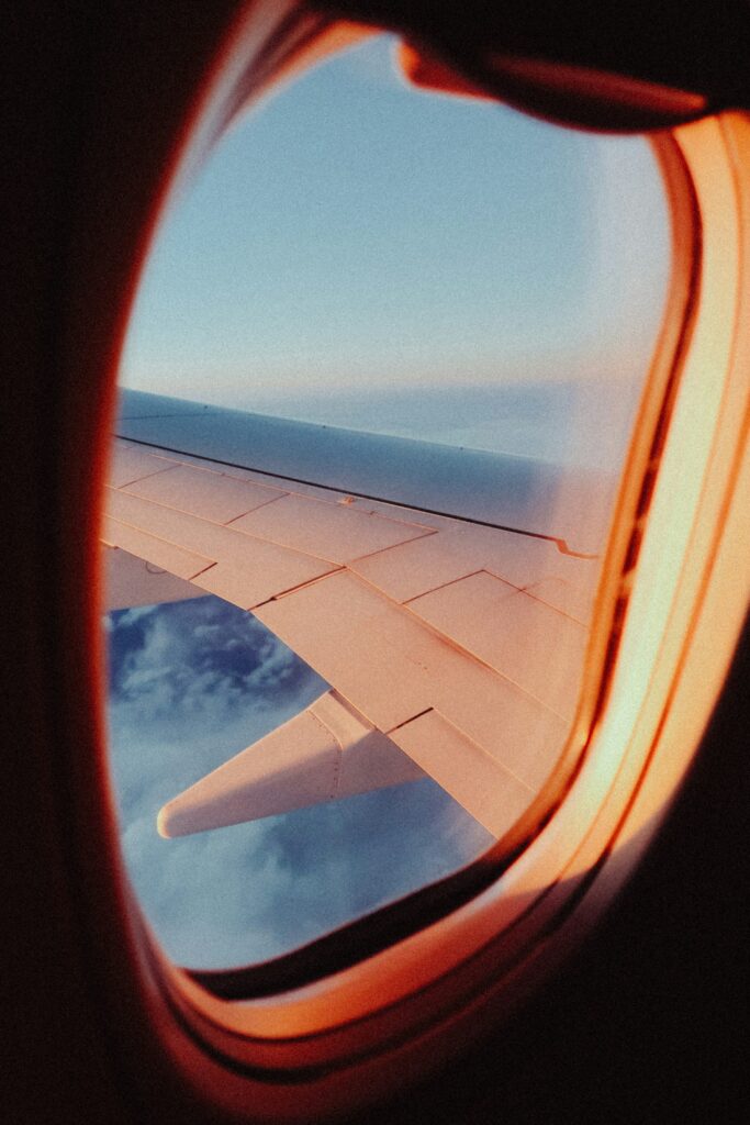 Airplane wing through a window for Farelyt short haul trips guide