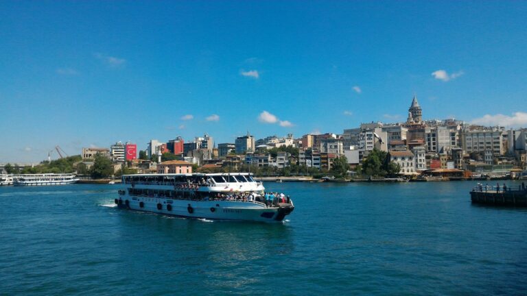 Passenger ferry crossing the Golden Horn in Istanbul with Galata Tower above the Karakoy waterfront